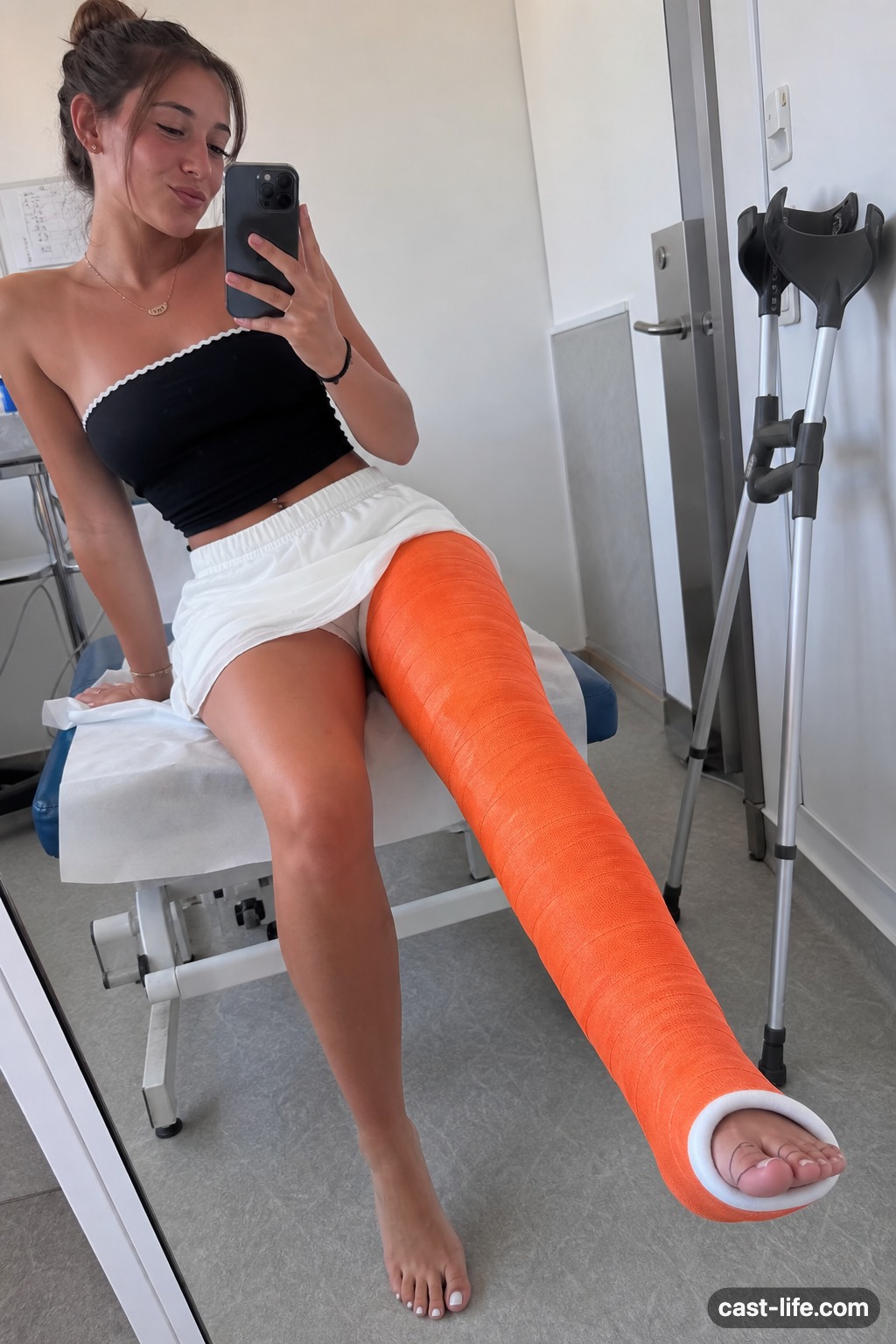 Woman with an orange long leg cast on a couch — aesthetic LLC photo example