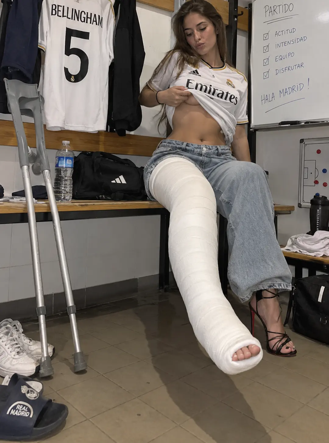 Football locker-room outfit with a realistic long leg cast and crutches