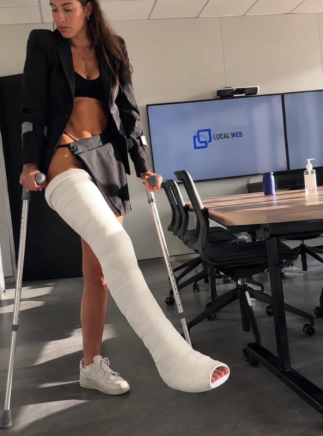Lifestyle scene in an office with a realistic long leg cast and crutches